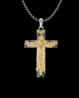 Handmade silver crucifix pendant with a gold vermeil Jesus figure on a textured cross, shown on a sterling silver chain.