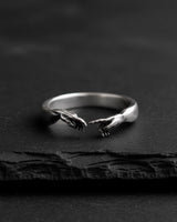 925 Sterling Silver Creation of Adam Ring with a detailed oxidized finish, resting on a dark, textured slate surface.