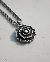 Handcrafted Tudor Rose Pendant on an intricate silver chain, angled to show the 3D depth and antique finish of the piece.