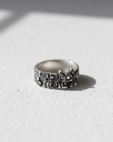 Side view of the Japanese Hannya mask ring in 925 silver, highlighting the intricate floral patterns on the band.