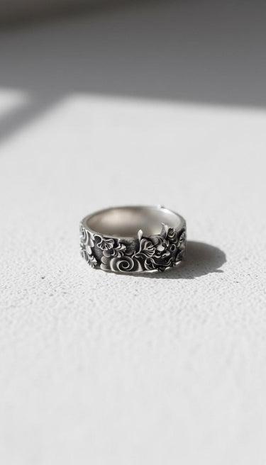 Side view of the Japanese Hannya mask ring in 925 silver, highlighting the intricate floral patterns on the band.