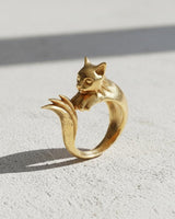Gold-plated version of the whimsical cat ring, showcasing the smooth, polished finish and sculptural design.