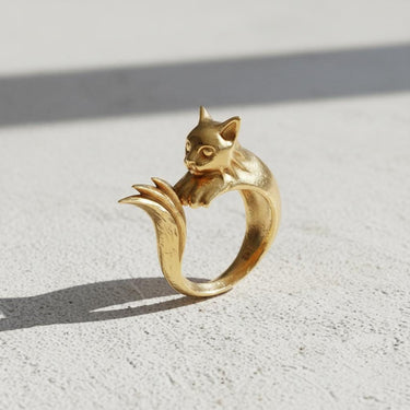 Gold-plated version of the whimsical cat ring, showcasing the smooth, polished finish and sculptural design.