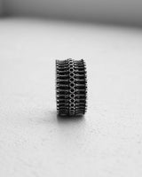 Front view of the 925 sterling silver biomechanical ring, highlighting the symmetrical, gear-like pattern and oxidized finish.