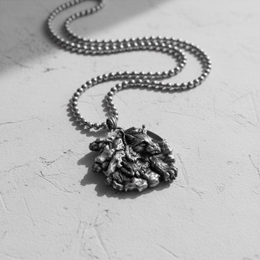 Artisan-crafted silver lynx pendant for men, angled view in black and white highlighting the 3D relief of the design.