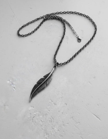 Handcrafted 925 sterling silver feather pendant necklace with an oxidized finish, displayed in full on a neutral surface.