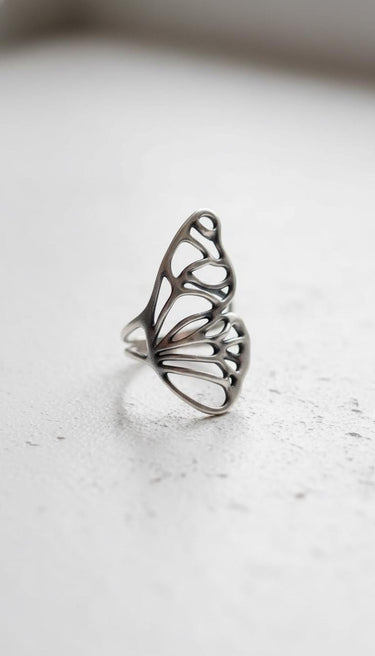 Angled view of the 925 sterling silver butterfly wing ring, highlighting the double band and the ethereal, skeletal wing structure.