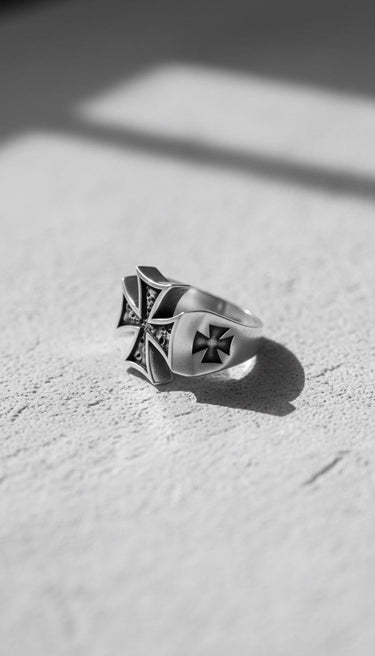 Side profile of the Silver Maltese Cross Ring displaying the engraved cross detail on the shank, with a dramatic shadow.