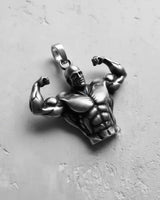 Angled view of the silver bodybuilder pendant, highlighting the detailed muscle carving and polished finish on the arms.