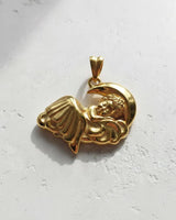Gold-plated version of the sleeping angel pendant, highlighting the polished finish and celestial design from an angle.