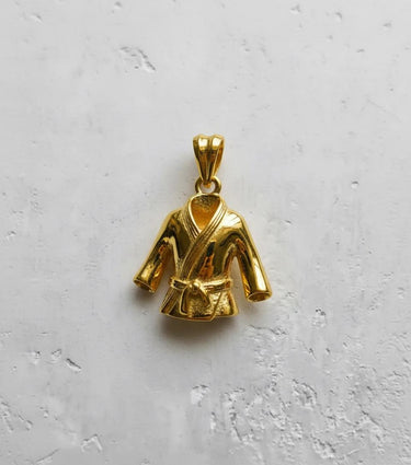Top-down view of the gold-plated martial arts uniform pendant, highlighting its polished finish and detailed lapels.
