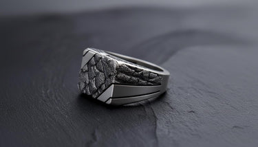 Side profile of the men's brutalist nugget ring, showcasing the deep texture and the smooth, geometric shank design.