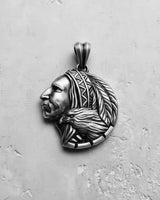 Oxidized Silver Indian Chief Pendant showing intricate feather and eagle details on a light grey textured surface.