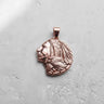 Rose gold plated 925 sterling silver Indian chief pendant with eagle detail on textured white background