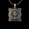 Silver Lion Pendant with detailed mane and Victorian filigree frame, shown on a silver chain against a black background.