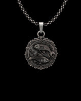 Detailed close-up of the handcrafted sterling silver Pisces pendant, showcasing the ornate border and intricate fish scales.