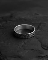 Top-down view of the 925 sterling silver moon ring on a dark slate surface, highlighting the detailed lunar craters.