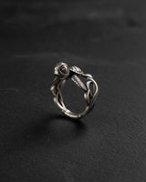 Silver Turtle Ring with a detailed, small turtle on a woven band, shown against a dark, textured slate background.