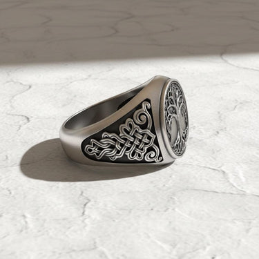 Angled view of the Silver Yggdrasil Ring highlighting the detailed Norse knotwork on the band and its oxidized finish.