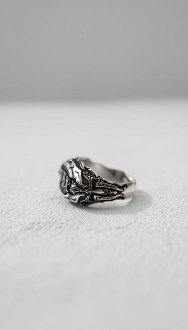 Side profile of the oxidized Silver War Ring, highlighting the intricate cross and scrollwork details along the band.