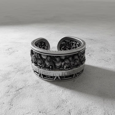 Oxidized sterling silver Last Supper ring showing the detailed bas-relief of Jesus and apostles on a textured surface.