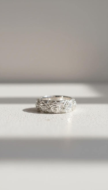 925 sterling silver Japanese rose ring featuring intricate floral relief pattern on textured white background