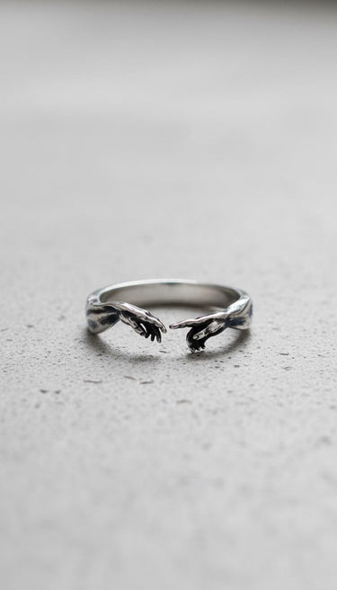 Front view of the adjustable Silver Creation of Adam Ring, showing the near-touching hands on a light gray background.
