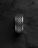 Top-down view of the handcrafted Dragon Scale Ring, highlighting the intricate, textured diamond pattern on a dark slate background.