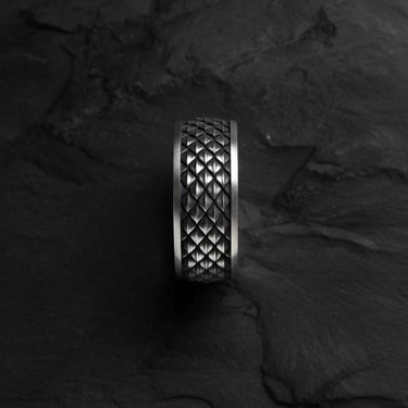 Top-down view of the handcrafted Dragon Scale Ring, highlighting the intricate, textured diamond pattern on a dark slate background.