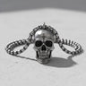 Artisan silver skull pendant with a bead chain, showcasing its oxidized details on a bright, textured surface.