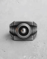Front view of the Silver Lantern Ring in oxidized 925 sterling silver, showing its geometric design and central orb.