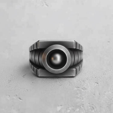 Front view of the Silver Lantern Ring in oxidized 925 sterling silver, showing its geometric design and central orb.