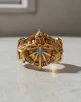 Front view of gold vermeil Silver Lucii Ring featuring a central gem and intricate mechanical details for fantasy gamers