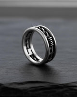 Angled view of the handcrafted silver barbed wire ring, revealing the unique geometric pattern on the inside of the band.