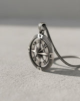 Close-up side view of the 925 silver compass pendant, highlighting the detailed ridged bezel and oxidized finish.