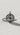Handmade silver compass pendant with North Star design and cardinal points, lying flat on a textured white surface.