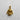Gold vermeil judo gi pendant showing detailed knotted belt and lapels, displayed on a light, textured studio background.