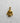 Gold vermeil judo gi pendant showing detailed knotted belt and lapels, displayed on a light, textured studio background.