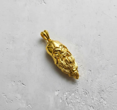 Angled view of the gold-plated Viking head pendant, highlighting the 3D relief of the beard and fierce facial expression.