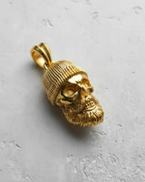 Gold vermeil bearded skull pendant showcasing the intricate hair texture of the beard and the ribbed knit beanie design.