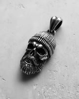 Oxidized 925 sterling silver bearded skull pendant with deep shadows in the eye sockets, emphasizing its gothic biker style.
