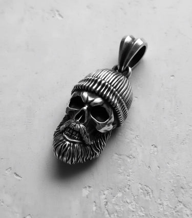 Oxidized 925 sterling silver bearded skull pendant with deep shadows in the eye sockets, emphasizing its gothic biker style.
