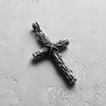 Oxidized Silver Wood Cross Pendant with detailed rope and grain texture, shown on a light grey concrete background.