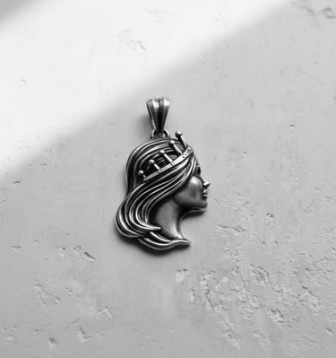 Side view of the Silver Queen Pendant in sterling silver, displaying the elegant crown and sculptural details of the hair.