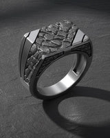 Angled view of the 925 silver nugget signet ring, highlighting the square face and the play of light on its rugged texture.