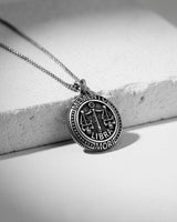 Oxidized Silver Libra Skull Pendant with Memento Mori text, showing detailed skull scales resting on a white surface.