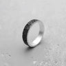 Silver moon ring with oxidized crater texture, showing the contrast with its polished sterling silver interior and edges.