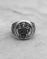 Silver Cthulhu ring with detailed tentacles and wings, showcasing the intricate handcrafted design on a grey stone surface.
