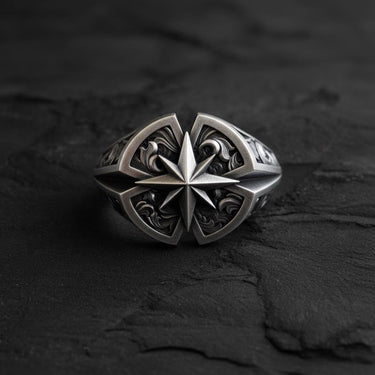Silver Compass Ring featuring a central North Star design with detailed engravings, displayed on a dark, textured slate background.