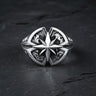 Men's sterling silver compass ring with an oxidized finish highlighting the detailed North Star and side engravings on a dark surface.